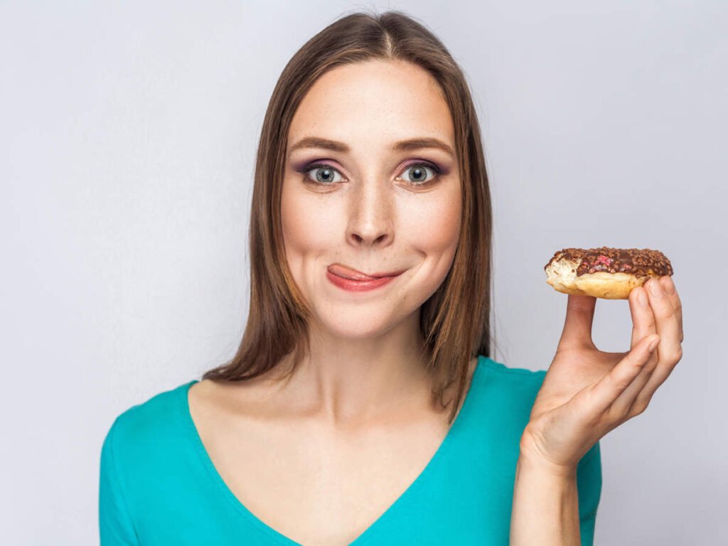 lady has sugar cravings for donuts